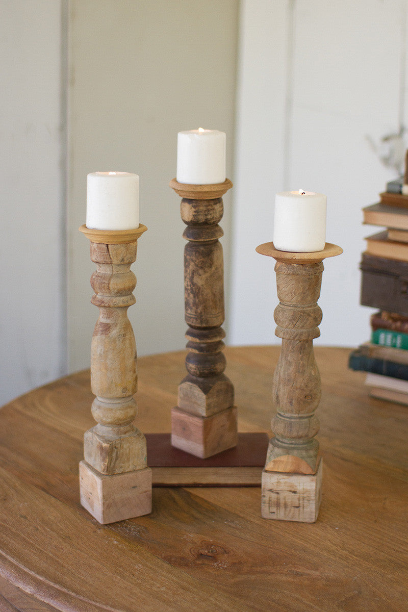 Set of three assorted wooden candle stands